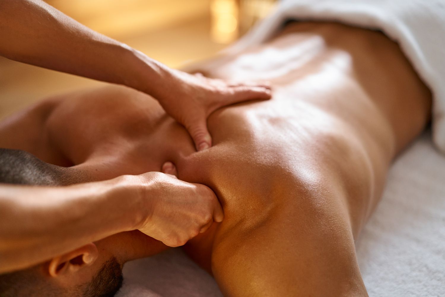 Therapist applying broad strokes to prepare muscles for deep work